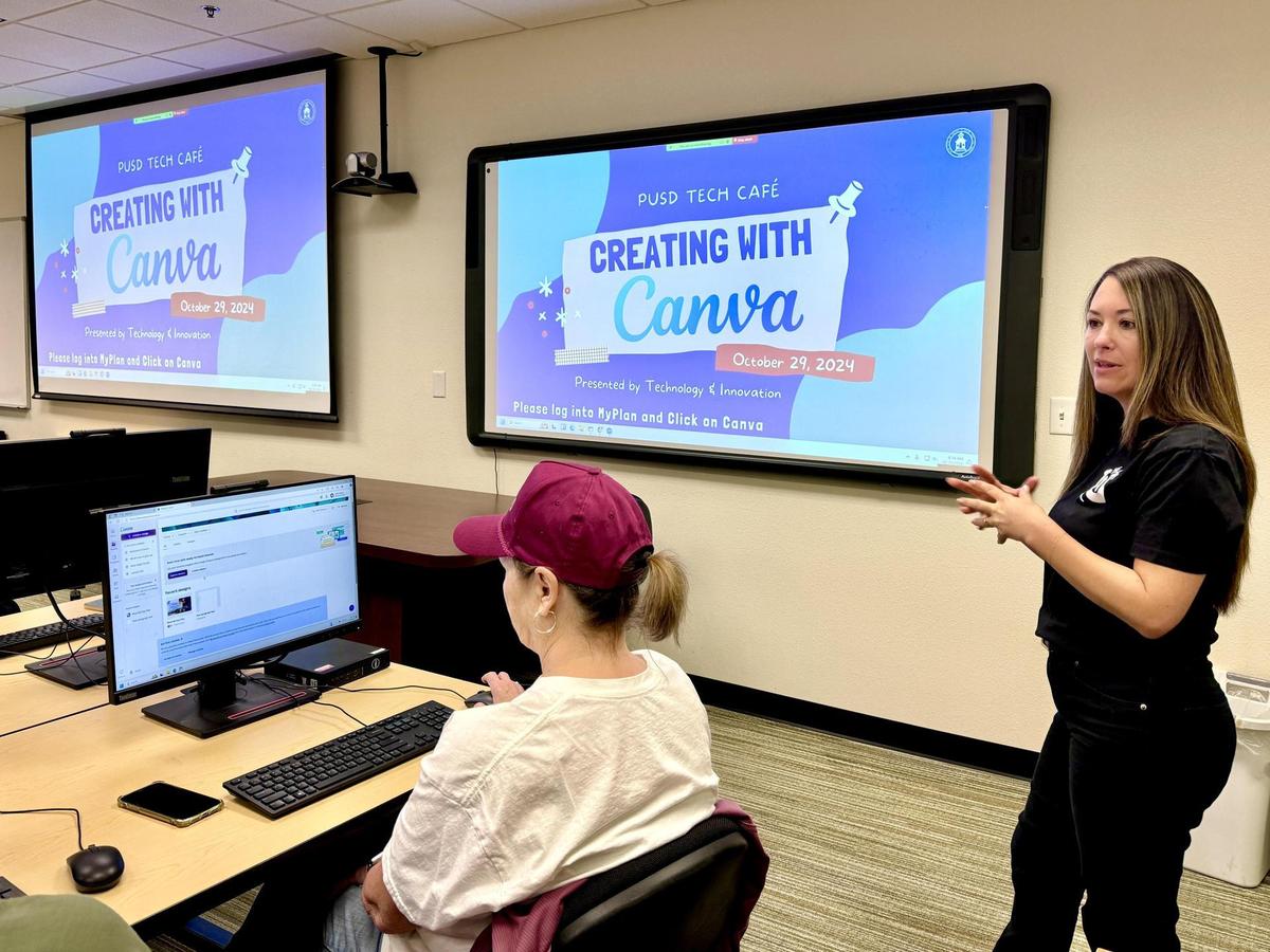 An educational technology coach is presenting on Canva at a Tech Cafe.