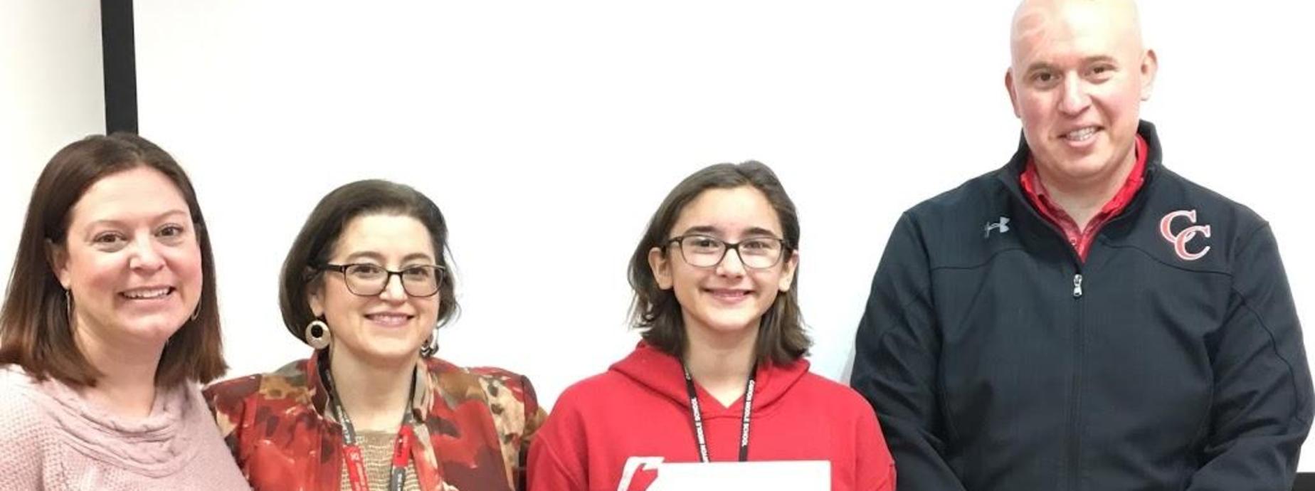 4 people standing in front of white board