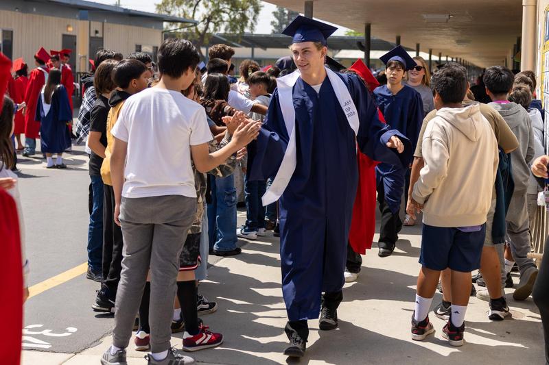 Former MSD Student giving a high five to Magnolia Students
