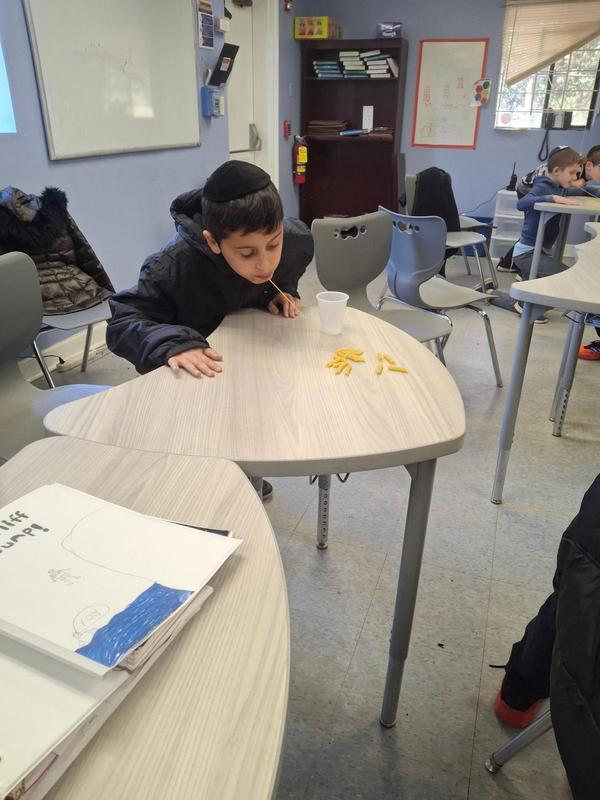 A boy participating in a minute to win it challenge in honor of publishing his personal narrative