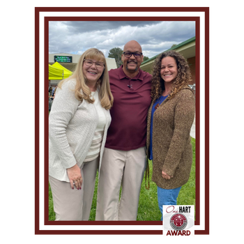 Two women and a man posing for a photo