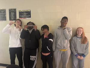 Students showing off their glow in the dark bracelets