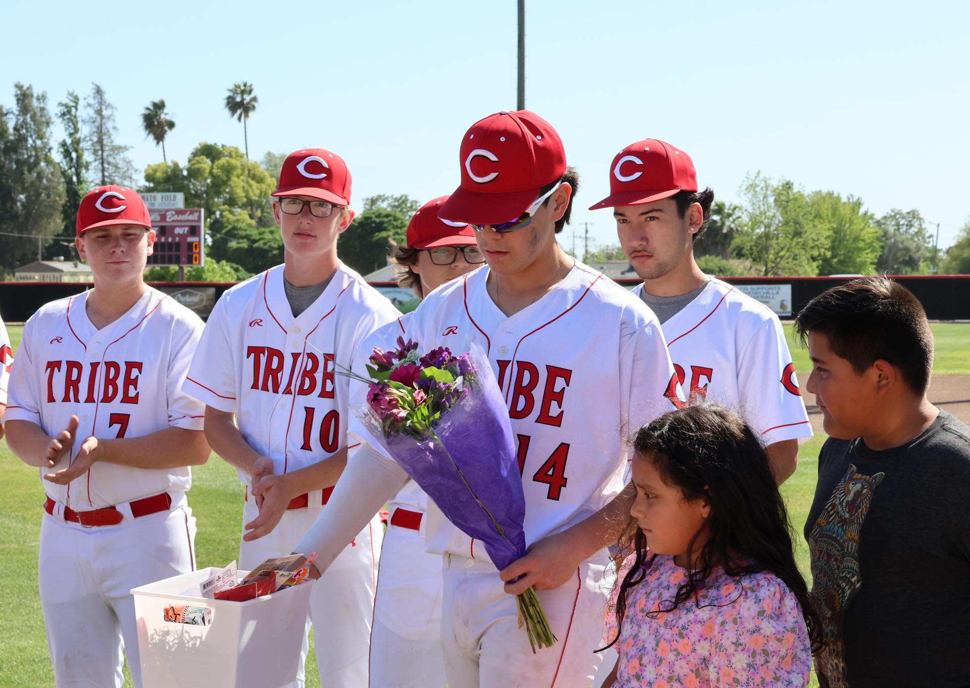 Seniors Posing With Teammates, Coaches, And Family