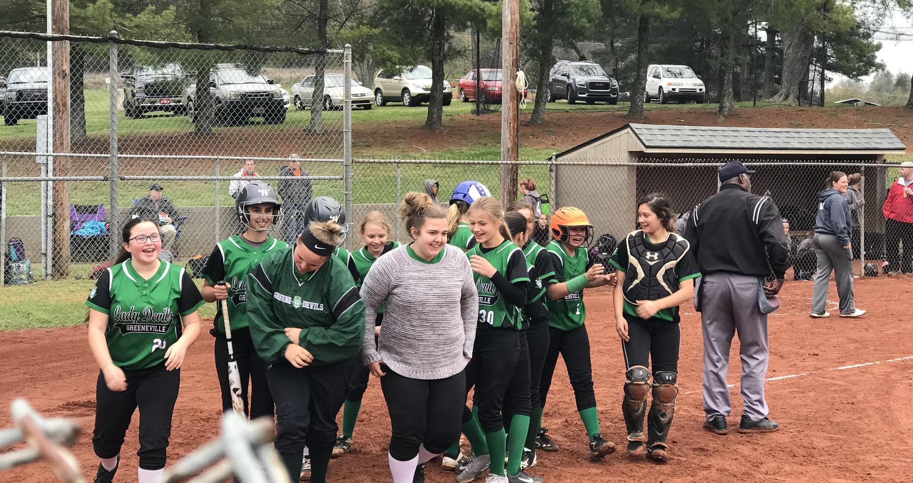 A picture of girls playing softball.