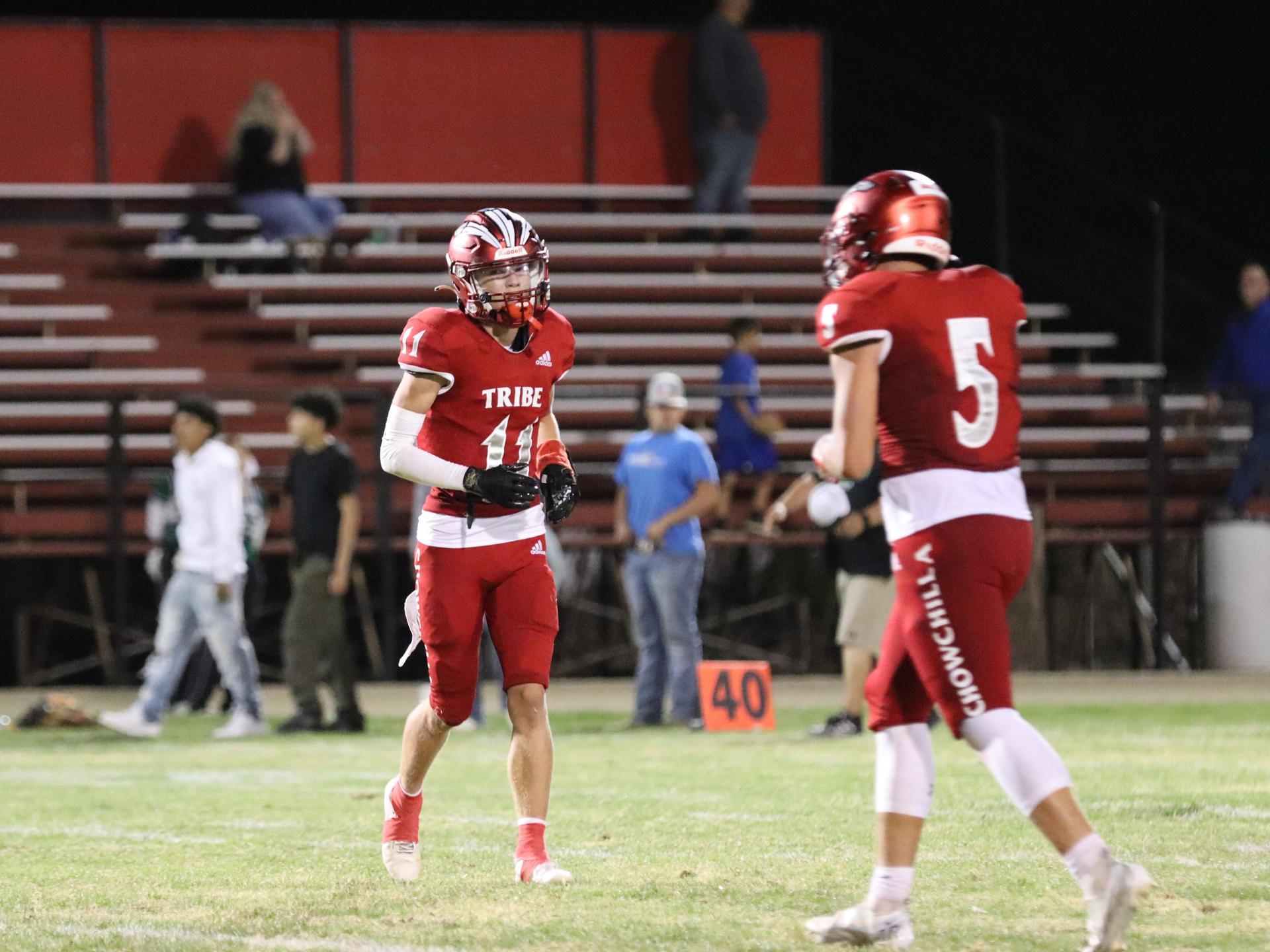 varsity football players in action against Riverdale