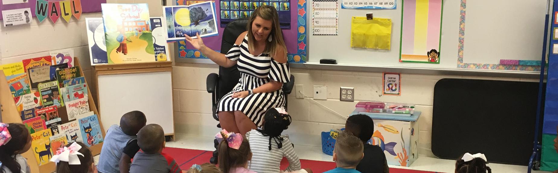 Kindergarten teacher reads to students on the first day of school.