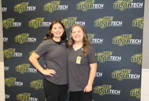 two high school students posing at CNA pinning ceremony