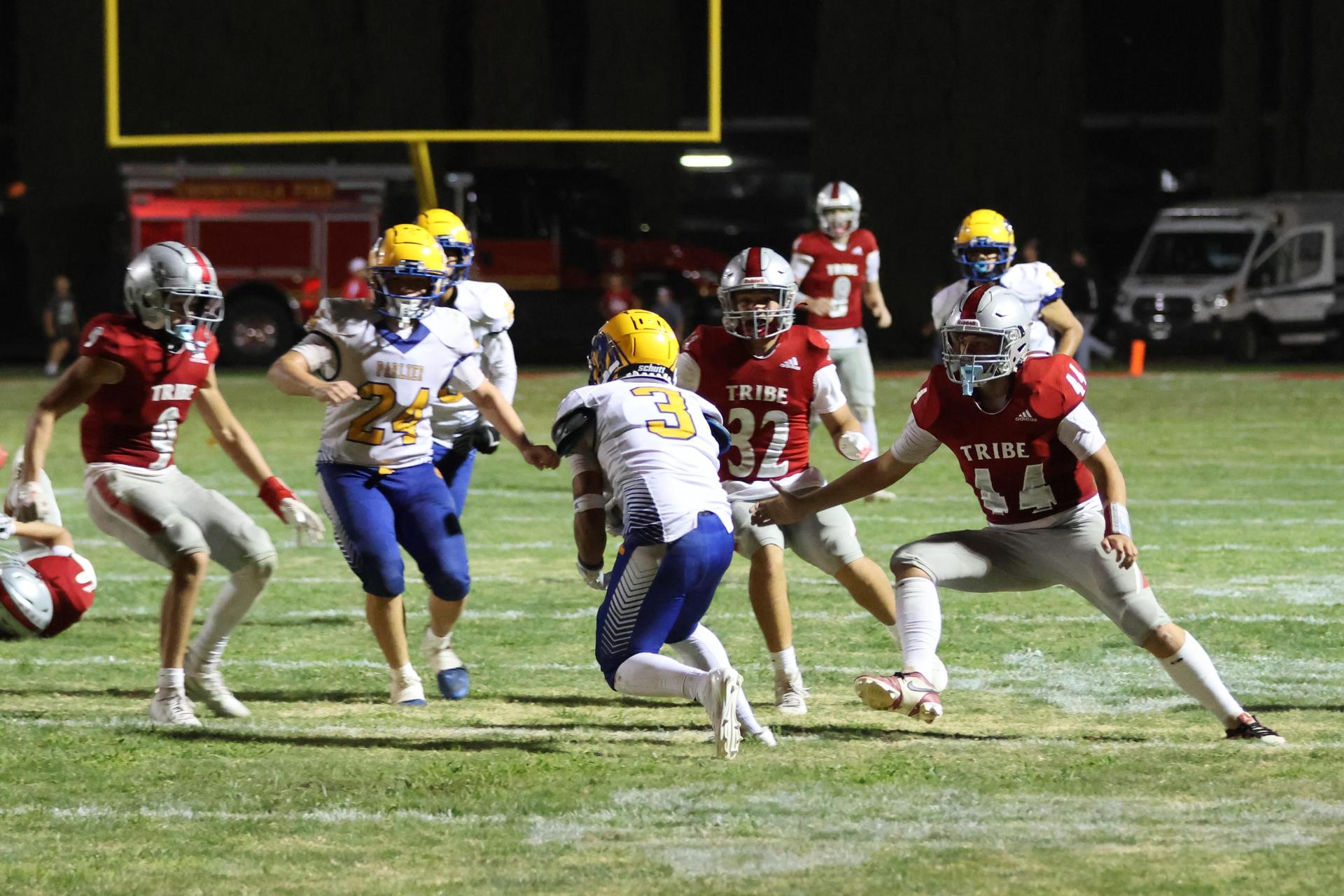Varsity football players in action against Parlier 71