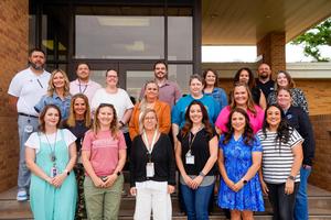 Staff Members in the Aspire Leader Academy Pose together on steps