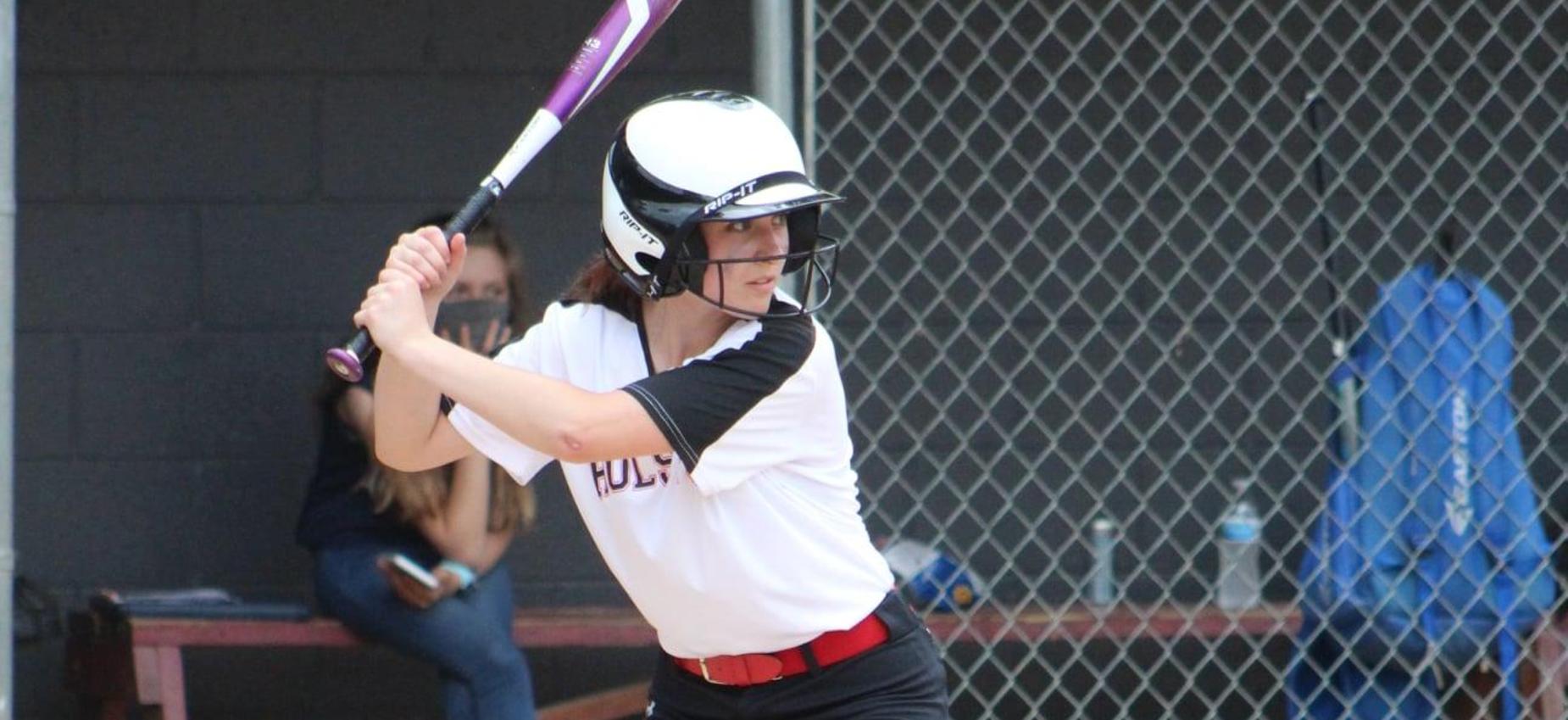 A softball player prepares to hit the ball.