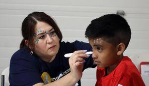 woman painting student face