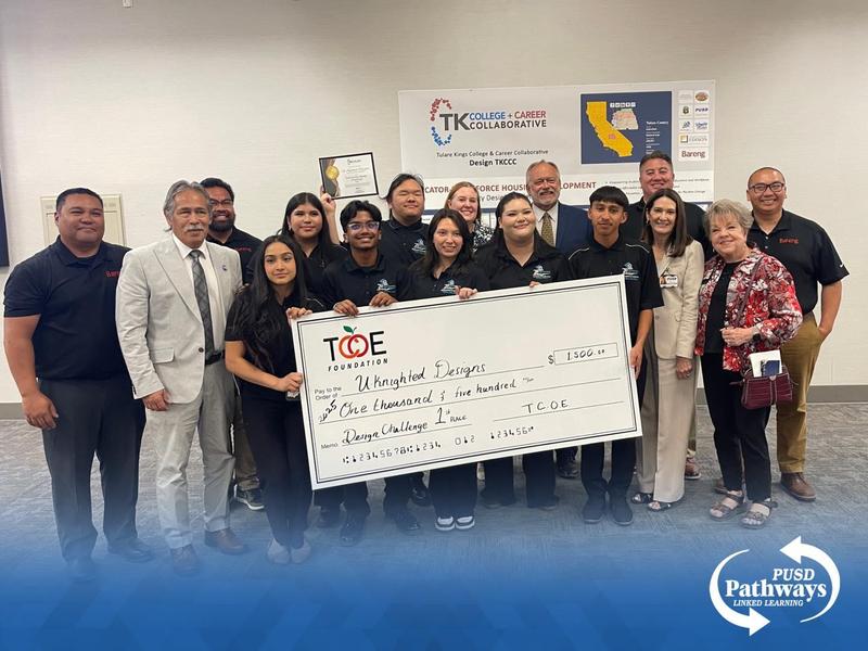 Harmony Magnet Academy students and their coach pose with representatives from Bareng and TCOE, proudly holding a large $1,500 check and certificate after winning first place in the Tulare County Internship Design Challenge.