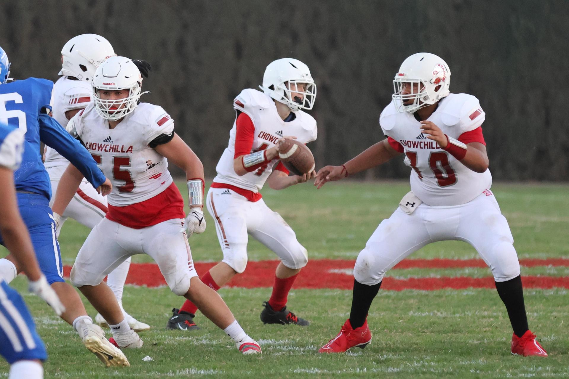 Junior Varsity football players in action against Caruthers