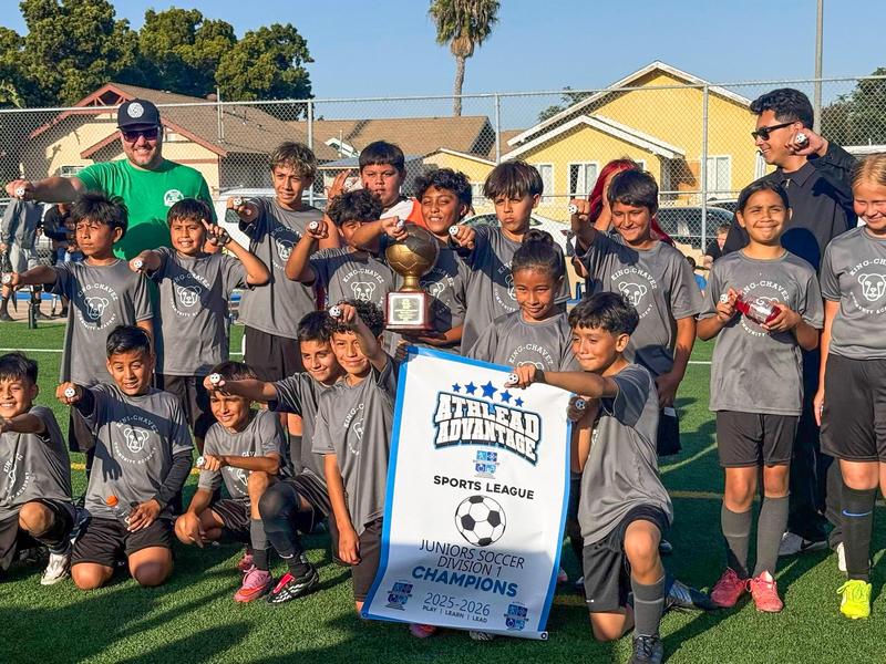4th - 5th Grade soccer team poses for photo with championship banner