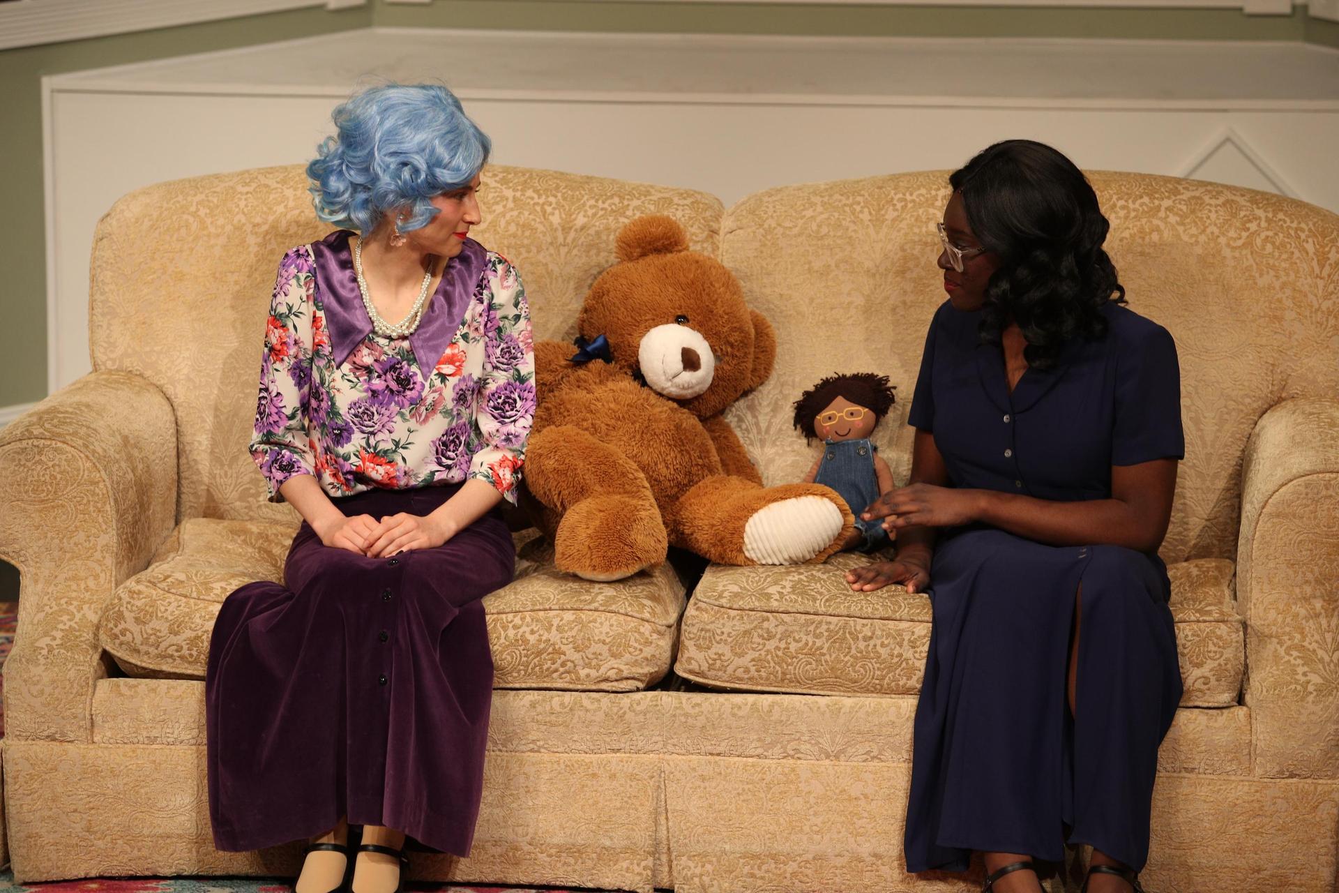 Characters sitting with teddy bear and doll