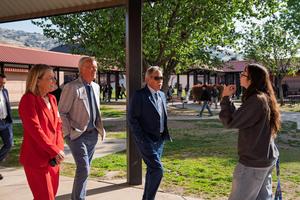 A student speaks with visiting district leaders on a school campus during the CSBA regional tour.
