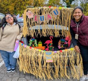 Student and staff decorate a trunk for halloween