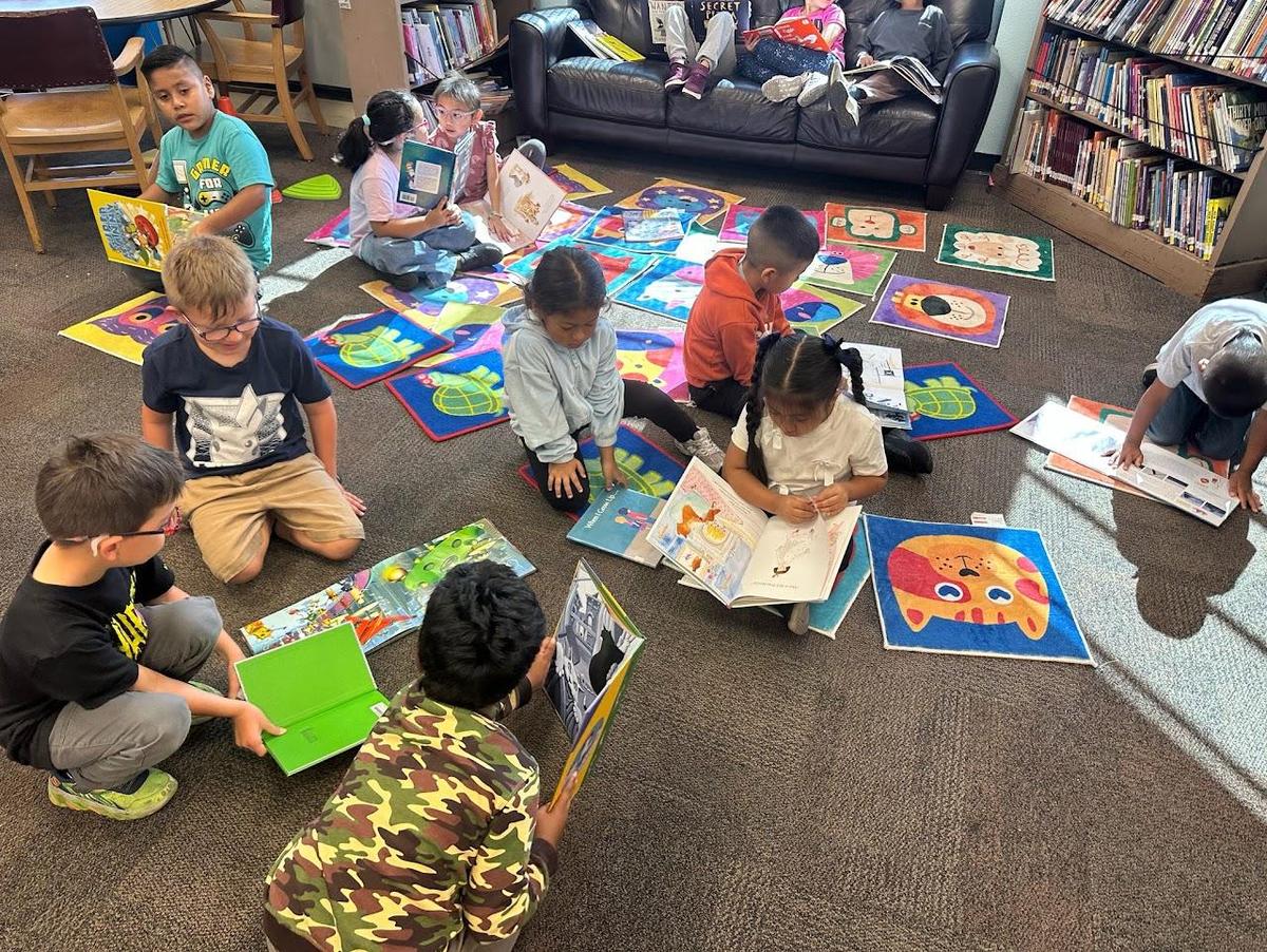 kids sitting on the floor and reading 