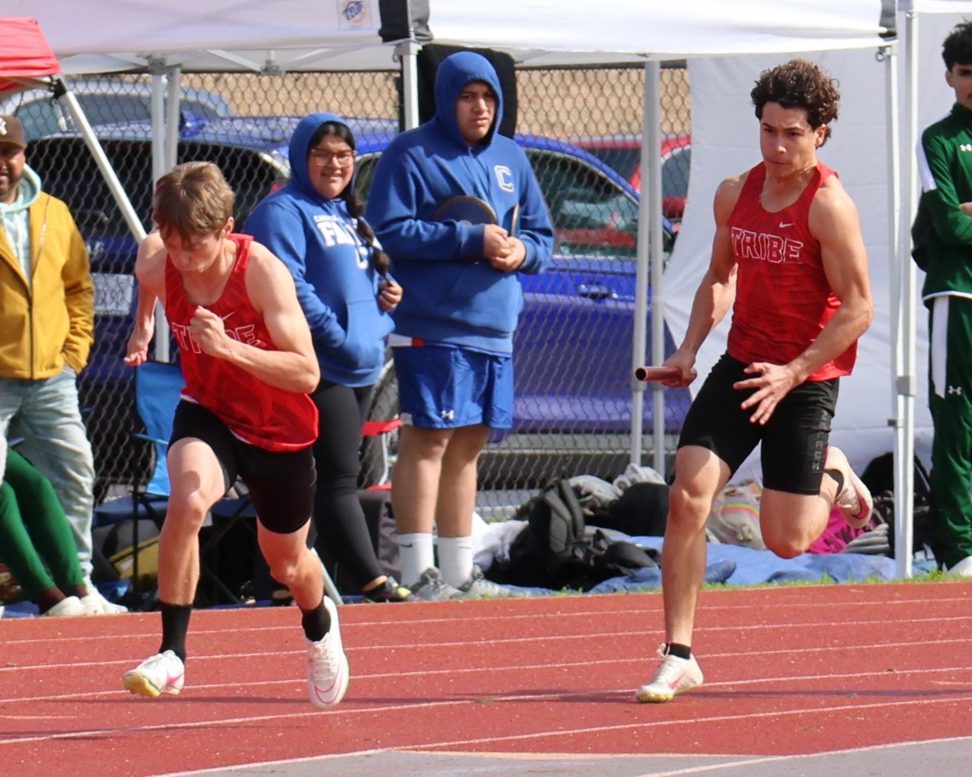 varsity boys running the four by 100 meter relay