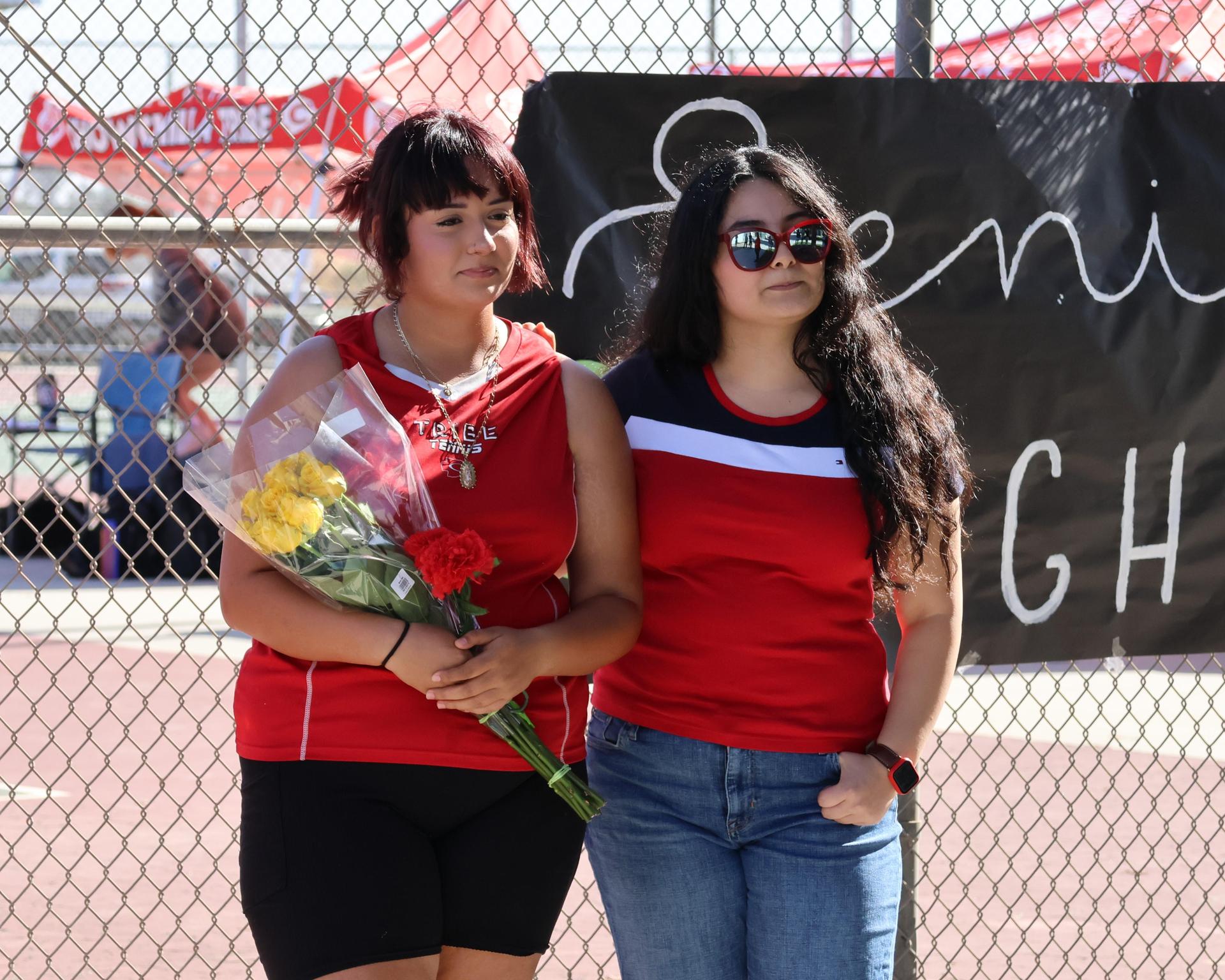 tennis players, family, and staff celebrating senior night
