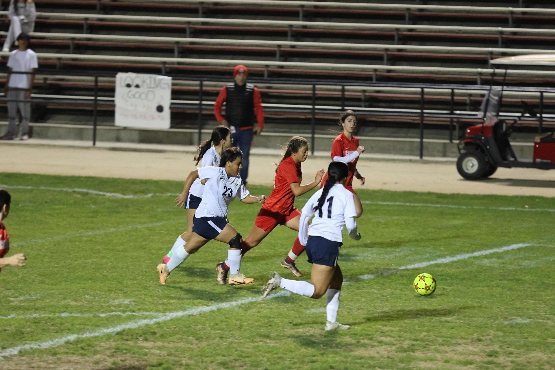 Varsity girls playing soccer against sunnyside