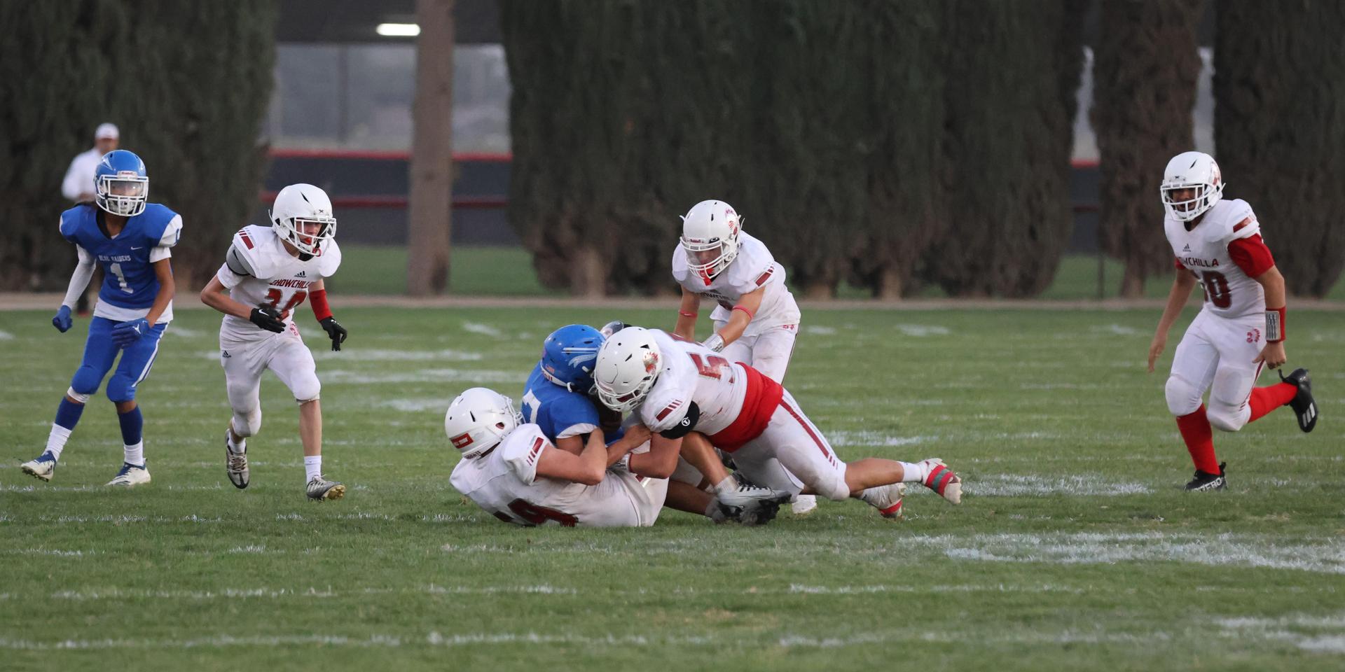 Junior Varsity football players in action against Caruthers