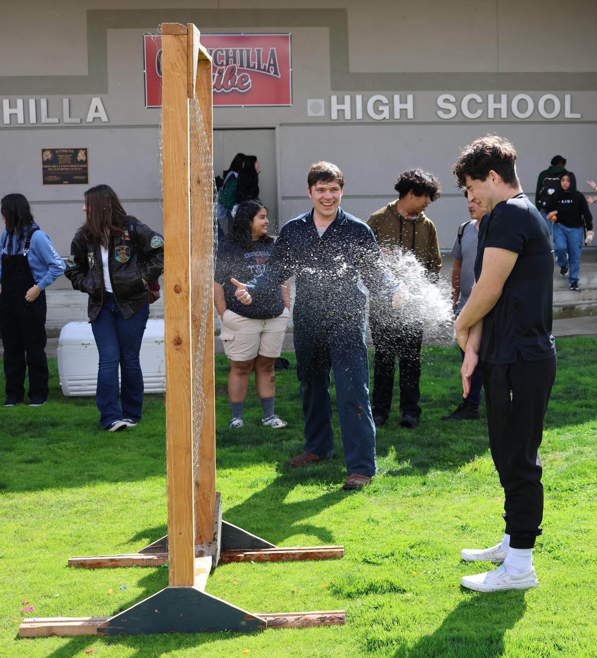students and staff enjoying the water balloon toss