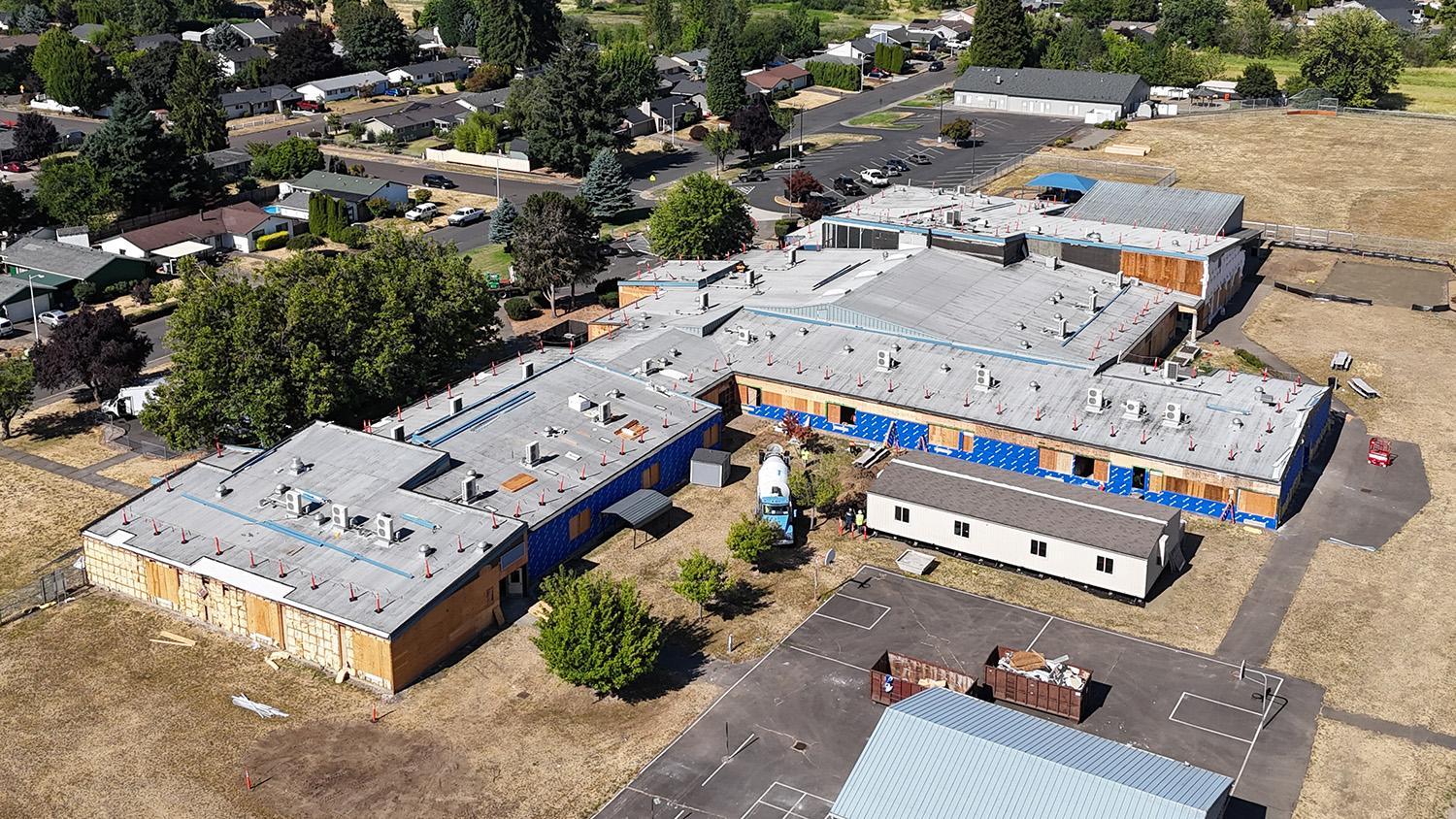 back aerial view of building with exposed siding