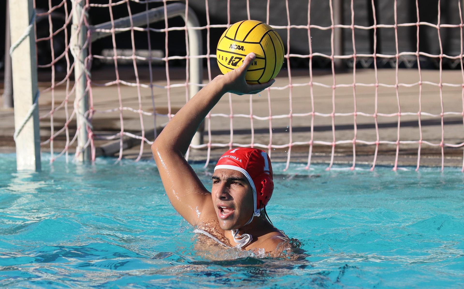 boys water polo players in action against hoover