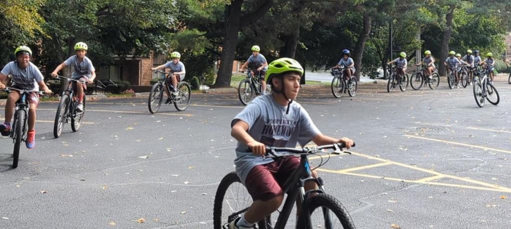 a group of students ride bikes