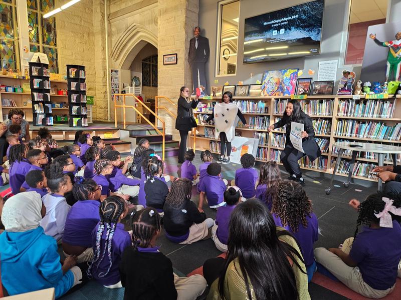 Scholars listen to a dentist presentation in the library