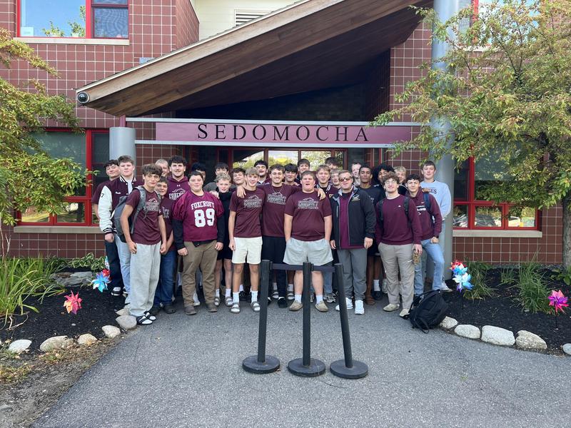 Football players in front of school