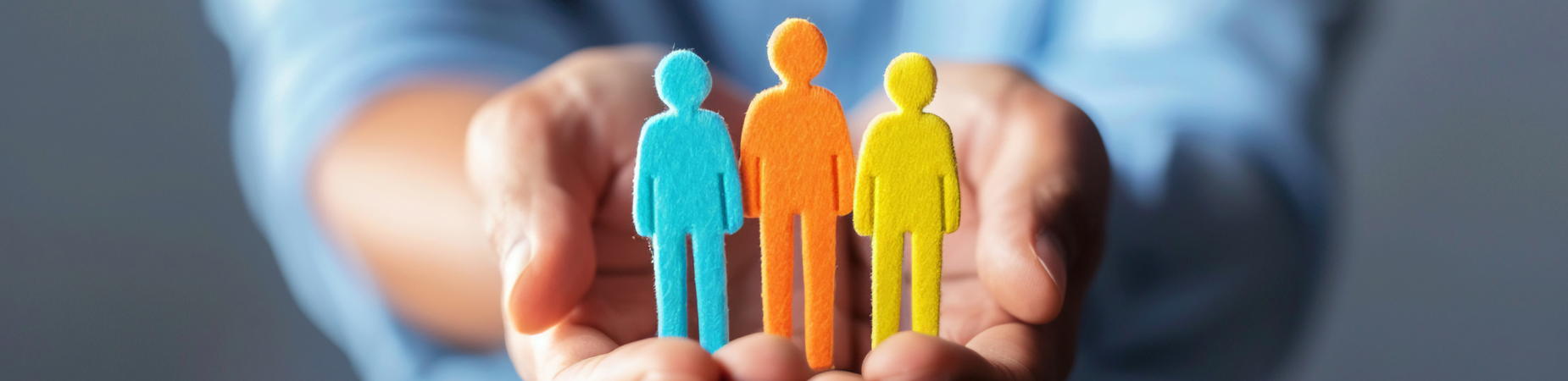 hands holding cutout paper people