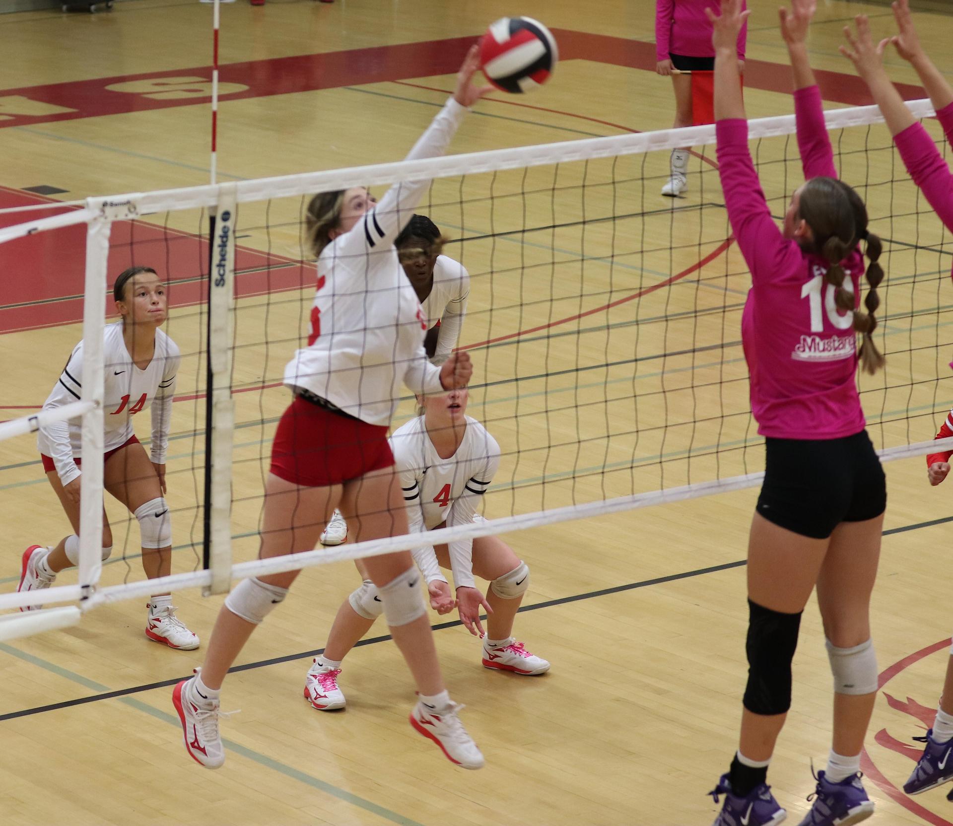 varsity volleyball players in action against Minarets