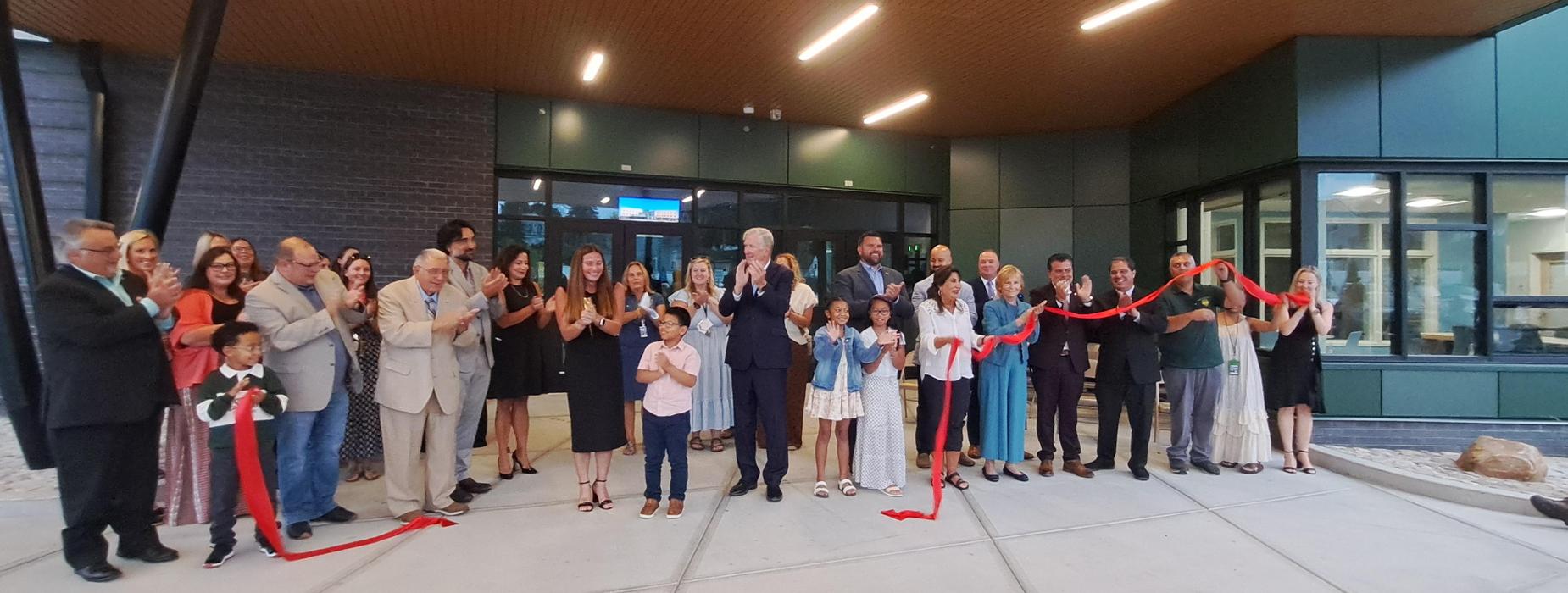 Gladstone Ribbon Cutting Ceremony with ribbon cut and all participants applauding.