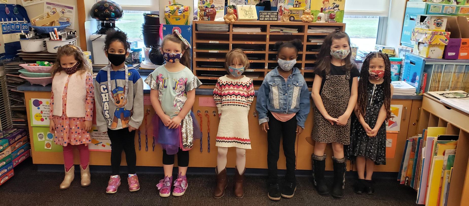 girls posing for camera, all dressed up for picture day