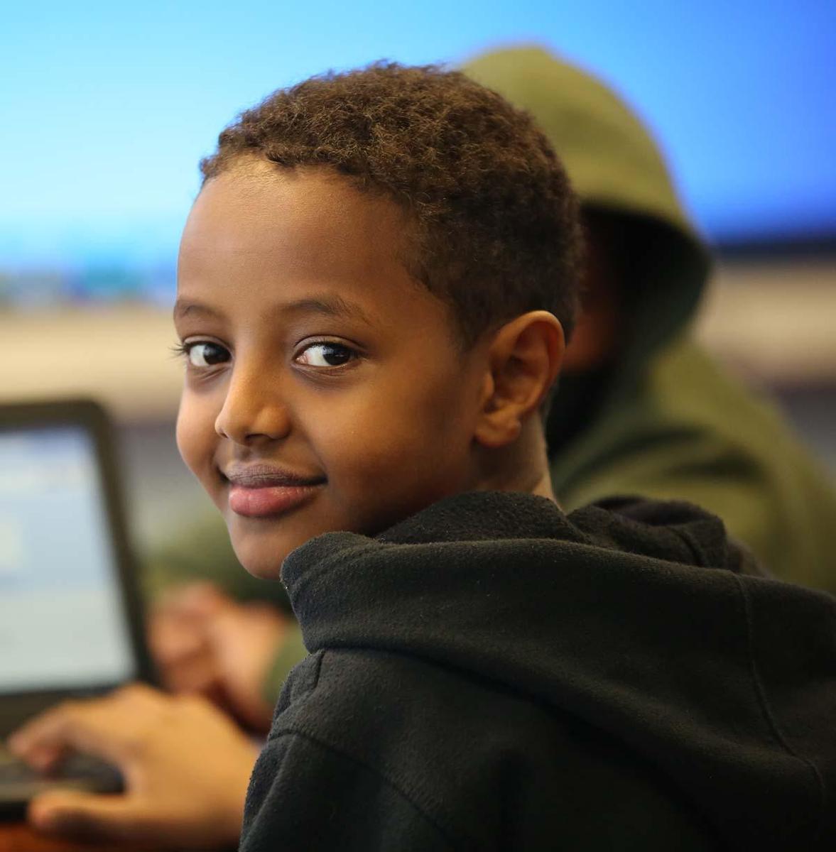 Student using a computer in a classroom.