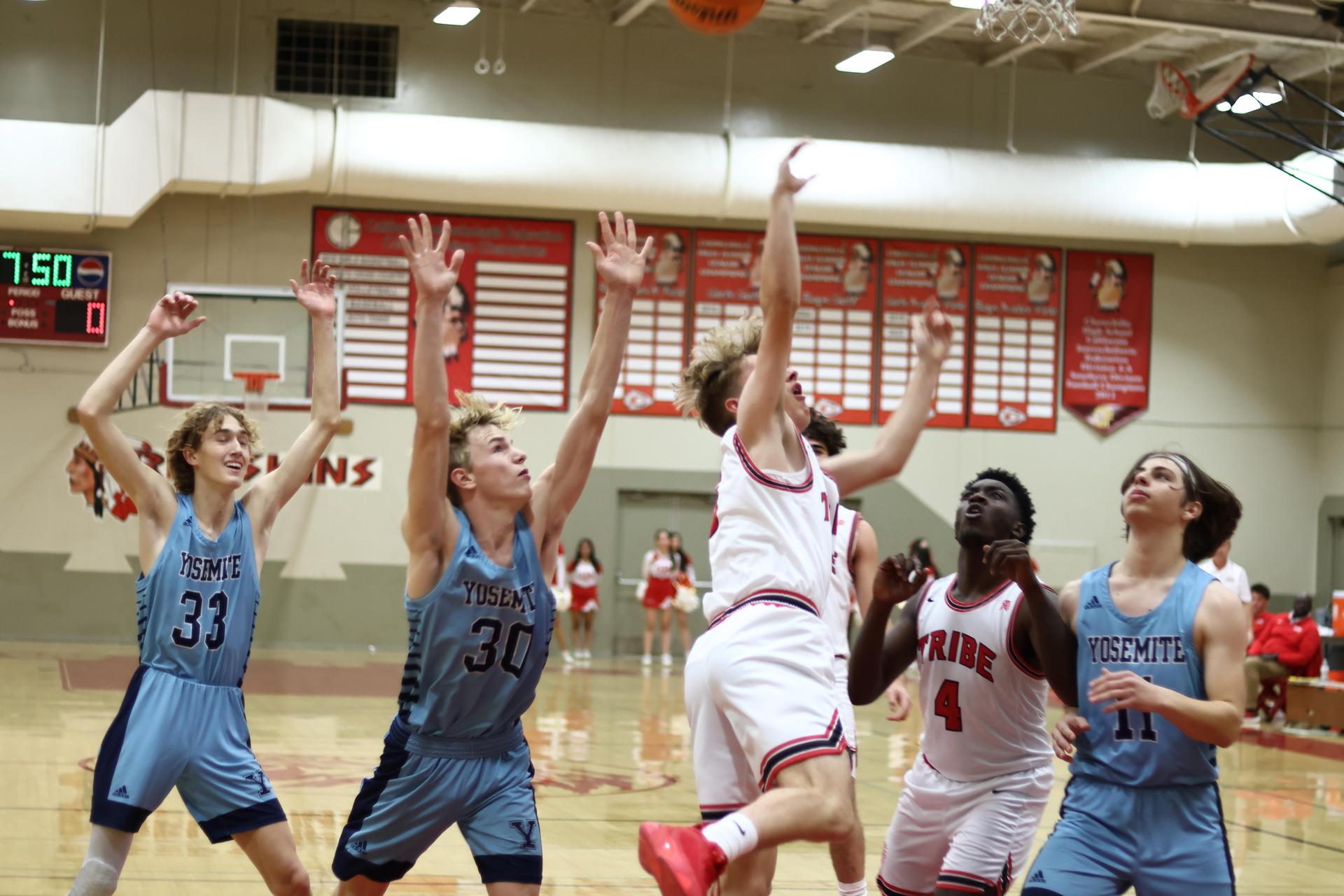 Varsity boys playing basketball against yosemite