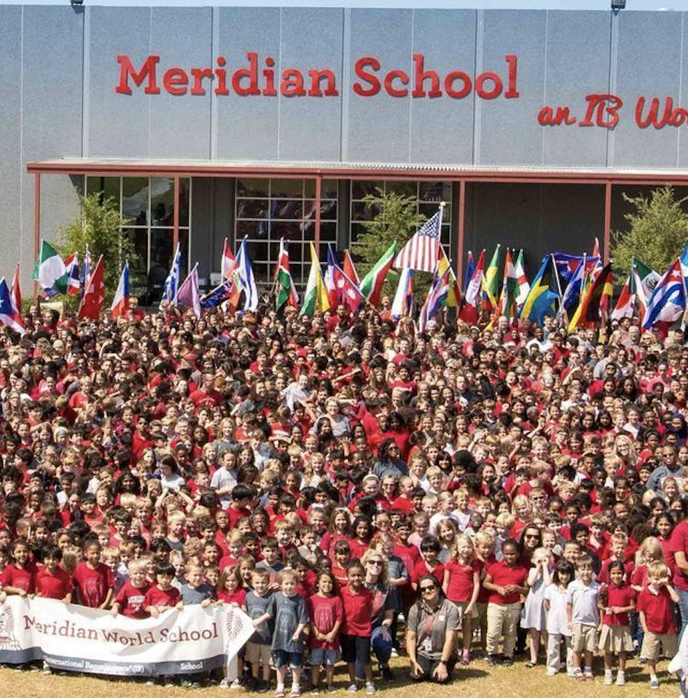 All of Meridian's students and staff stand in front of the Mays building