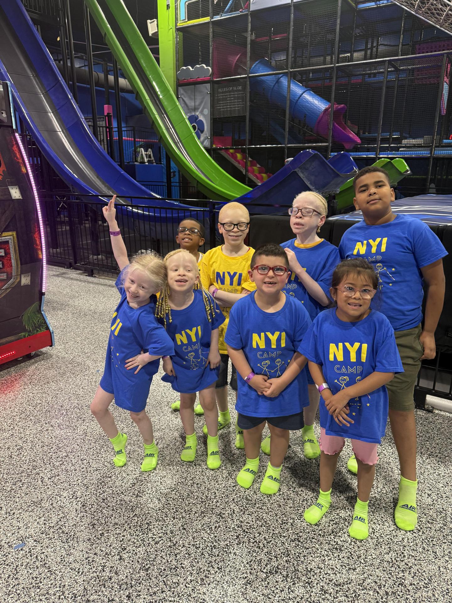 a group of campers in NYI Camp shirts smile