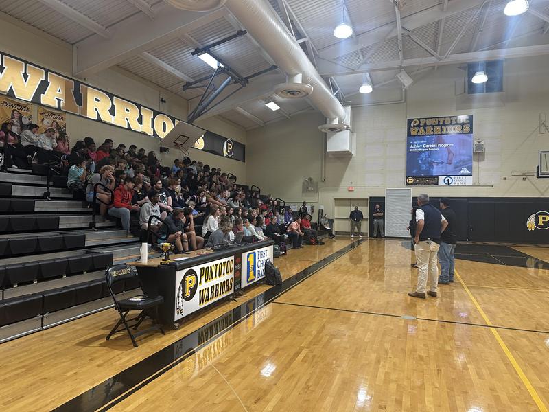 Ashley representatives speaking to senior class in the gym