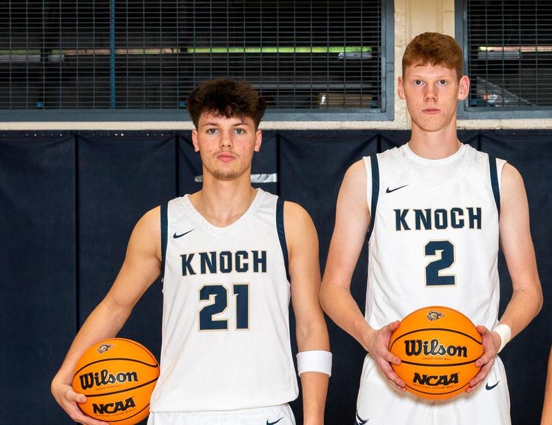 two boys basketball players dressed in uniforms