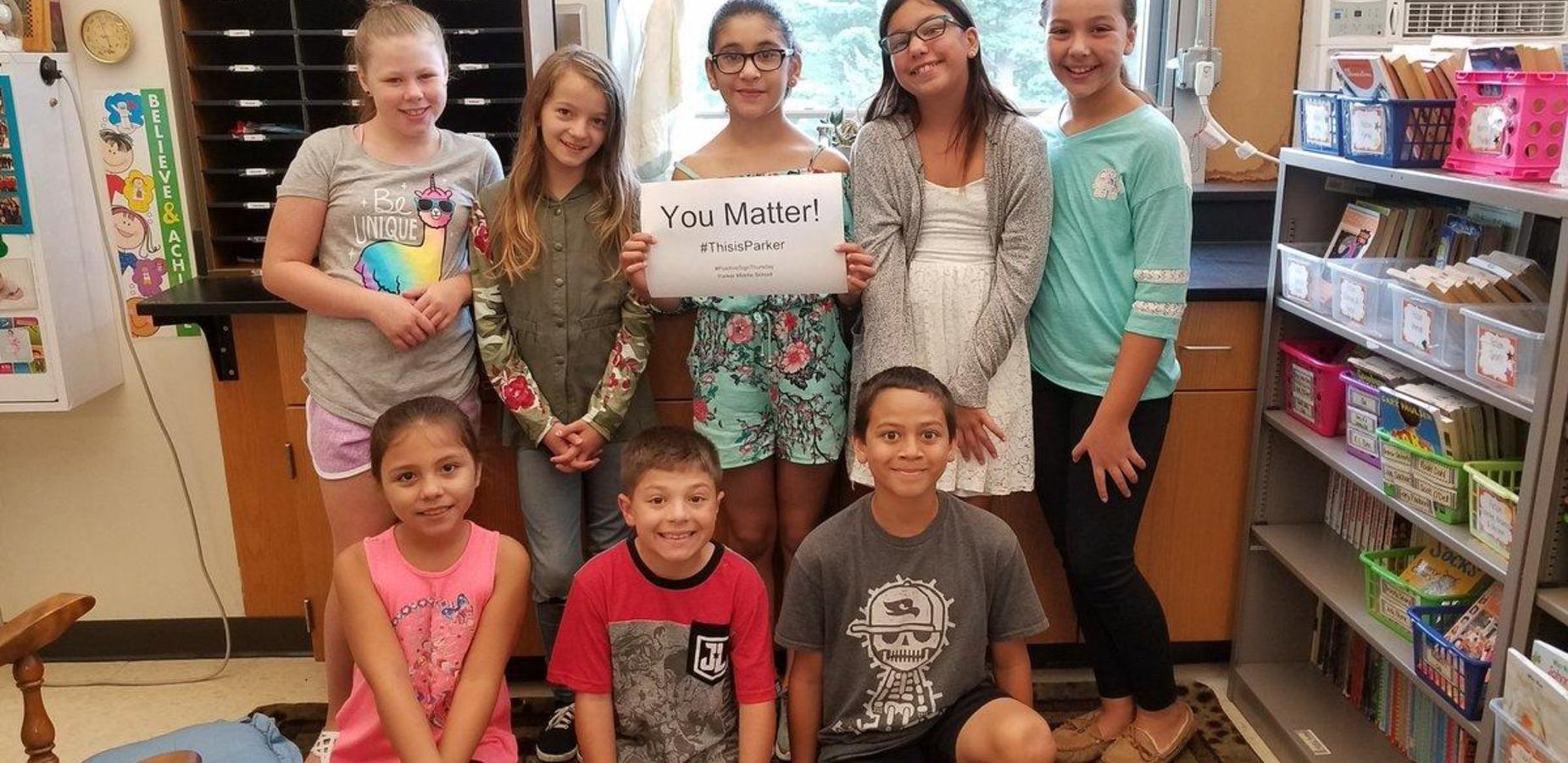 Students holding You Matter Sign