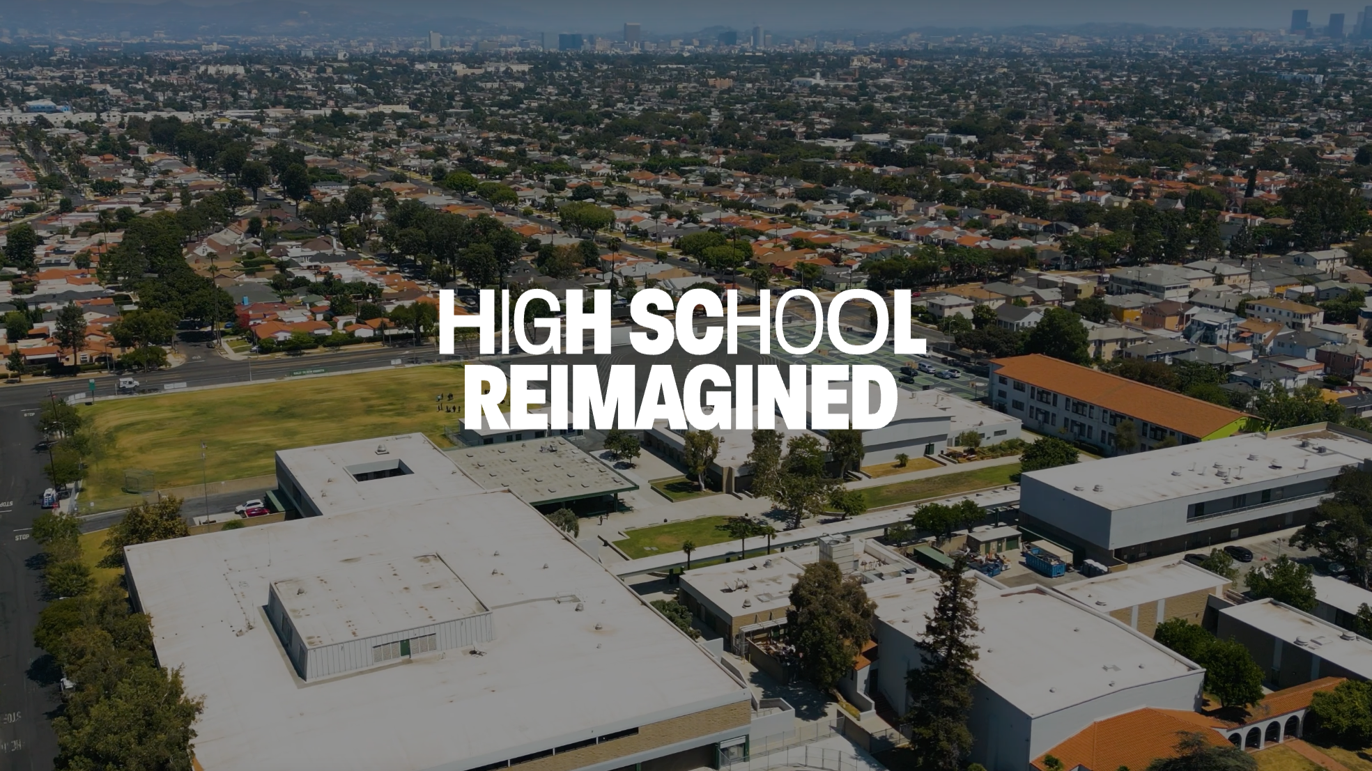 skyline and the top of iovine and young school with the words "high school reimagined" on top
