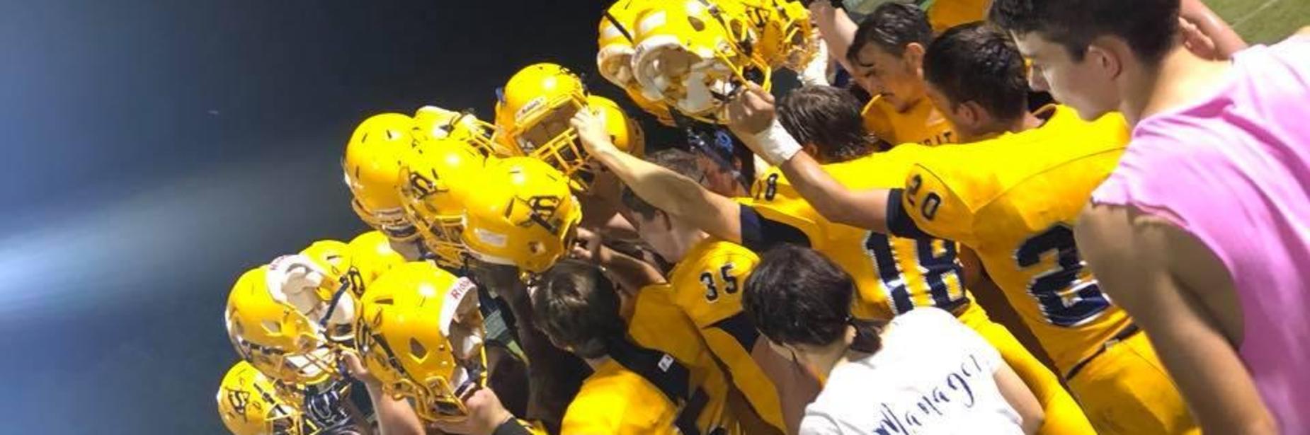 Football players in a huddle