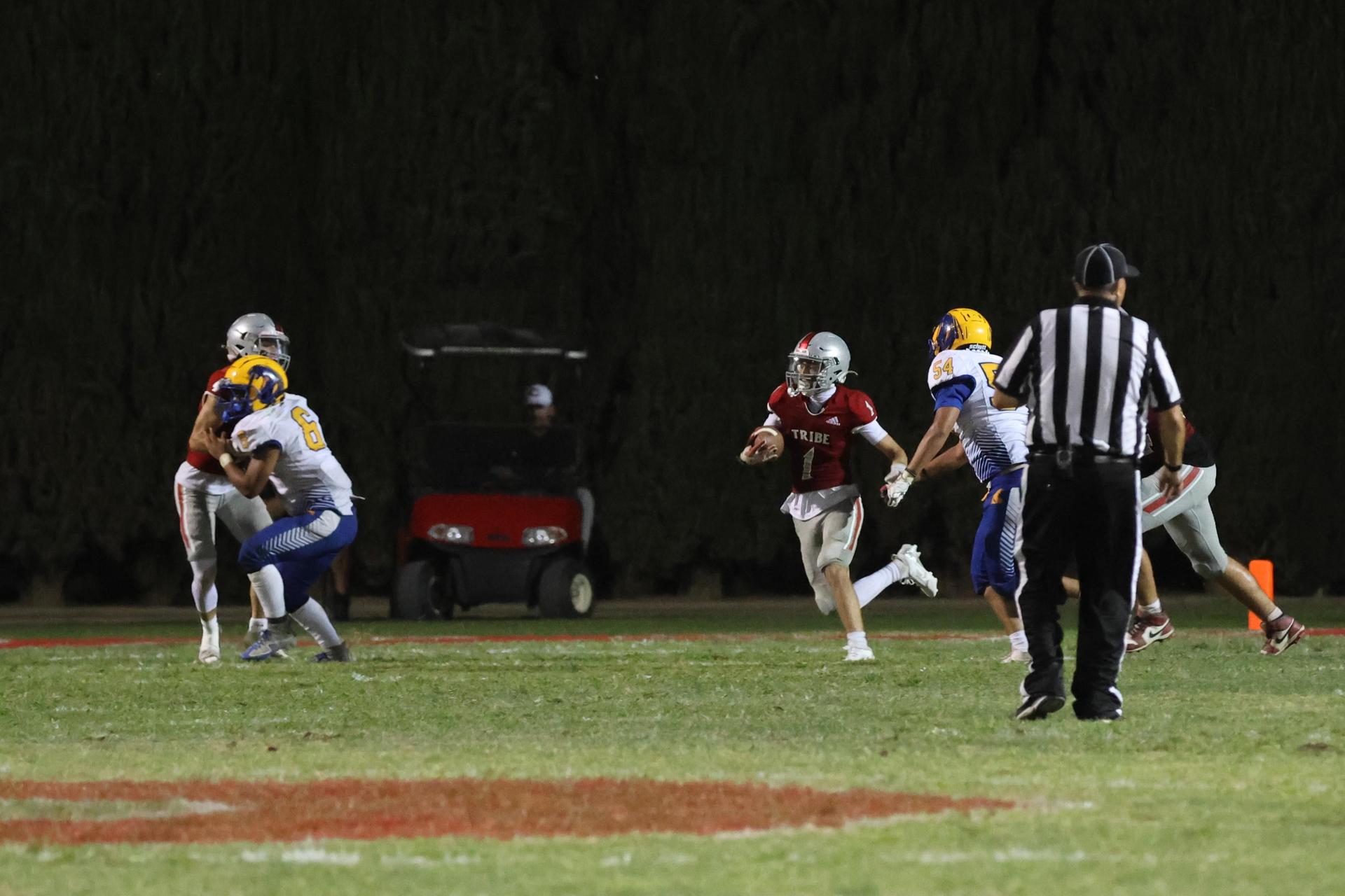 Varsity football players in action against Parlier 39