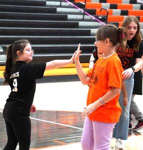 A student gets a high five from one of the Linkers.
