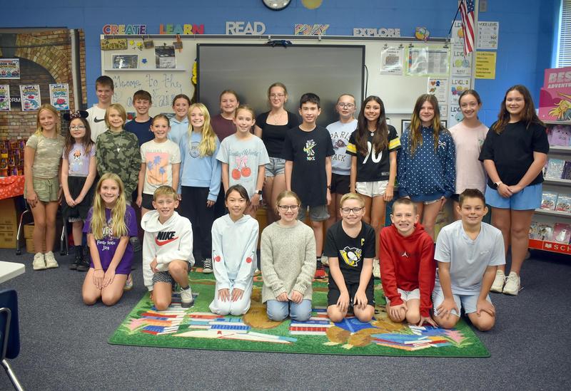A group of students posing together in a classroom setting.