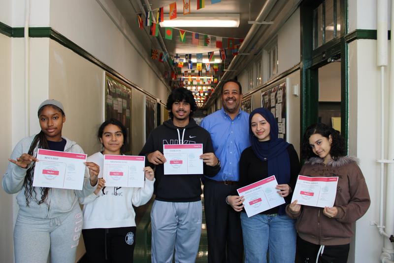 Students holding COMPTIA Tech+ certificates