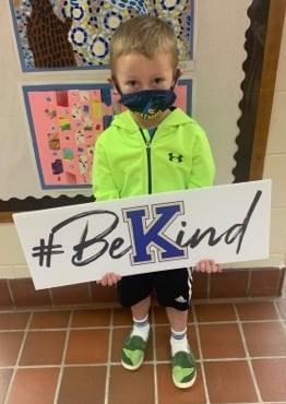 kids with bekind sign
